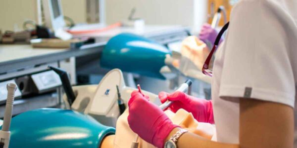 A dentist is performing a dental procedure on a patient, ensuring proper care and attention to their oral health.