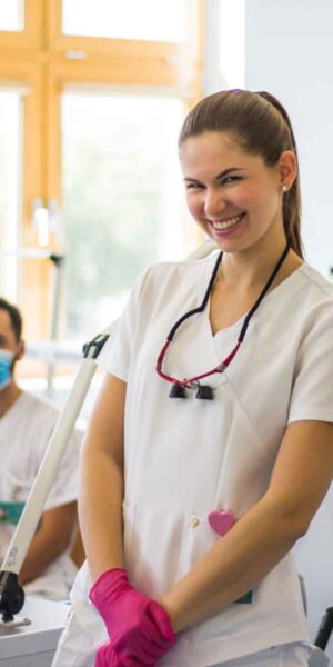 A smiling dental assistant in a dental office, exuding warmth and professionalism, ready to assist patients.