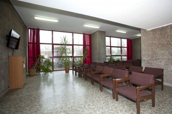 A cozy room featuring several chairs arranged around a television, creating a comfortable viewing space.