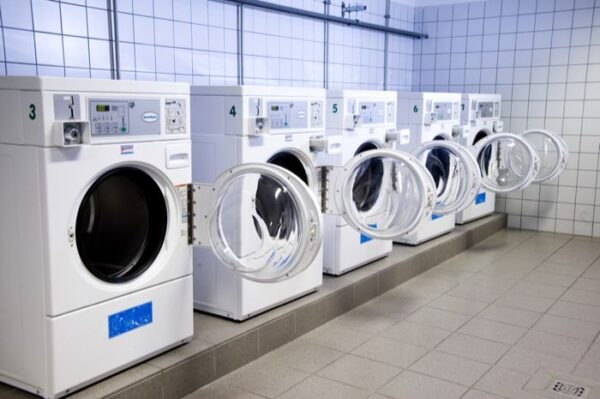 A series of washing machines arranged neatly in a clean laundry room, showcasing their modern design.